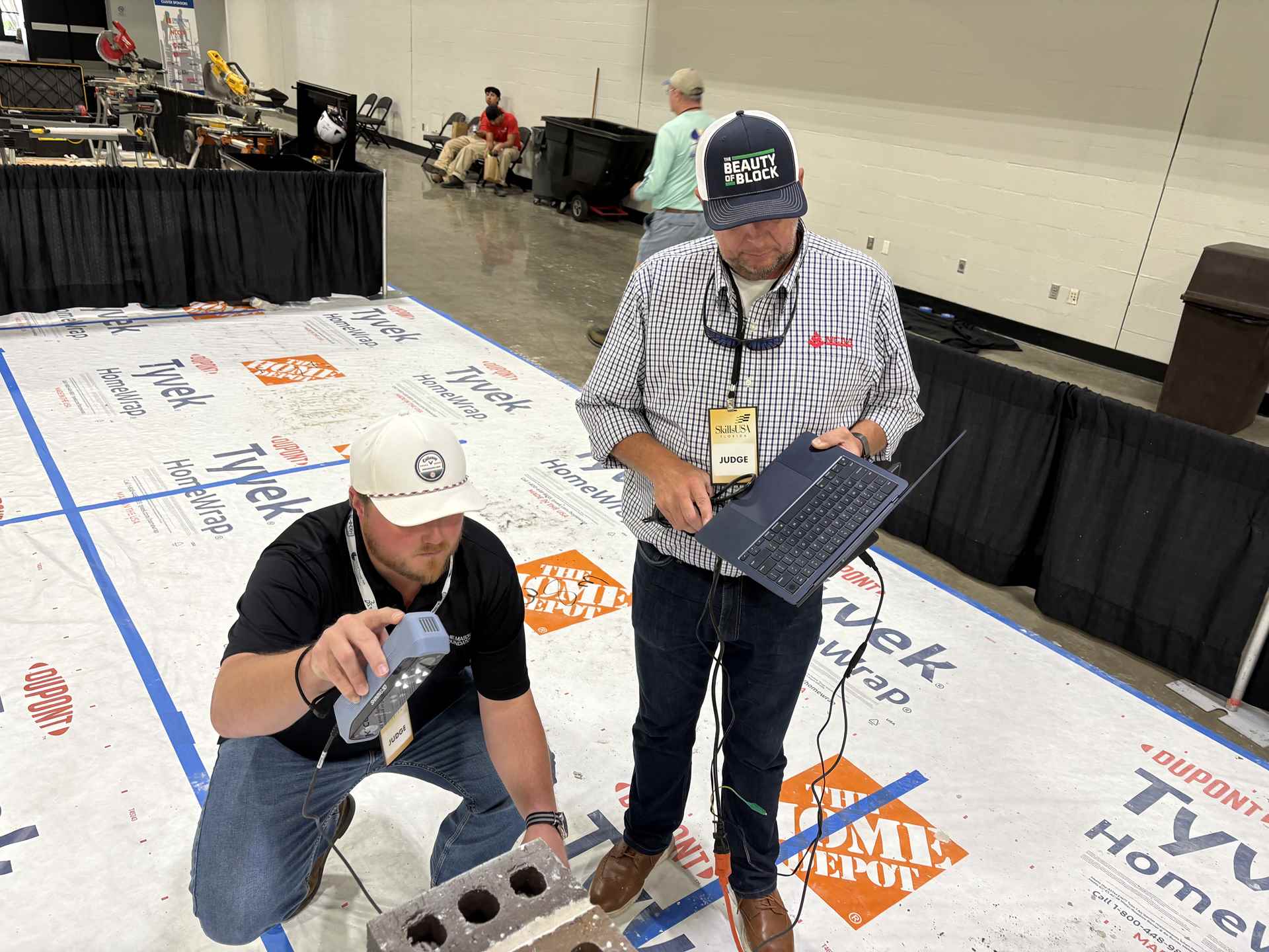 An instructor using a 3D scanner on a masonry wall.