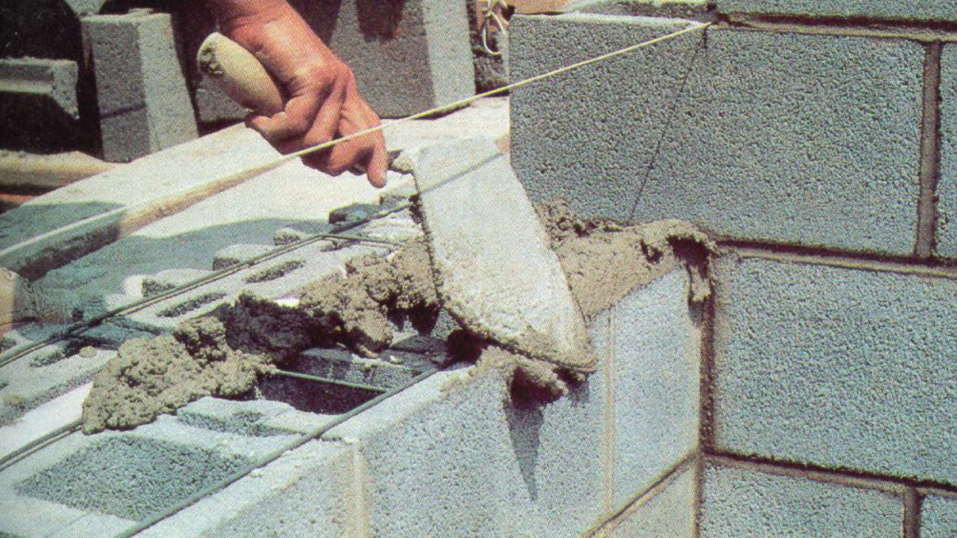 Joint reinforcement is laid dry on the CMU and covered with mortar. Photo courtesy of Masonry Construction. Joint reinforcement is laid dry on the CMU and covered with mortar. Photo courtesy of Masonry Construction.