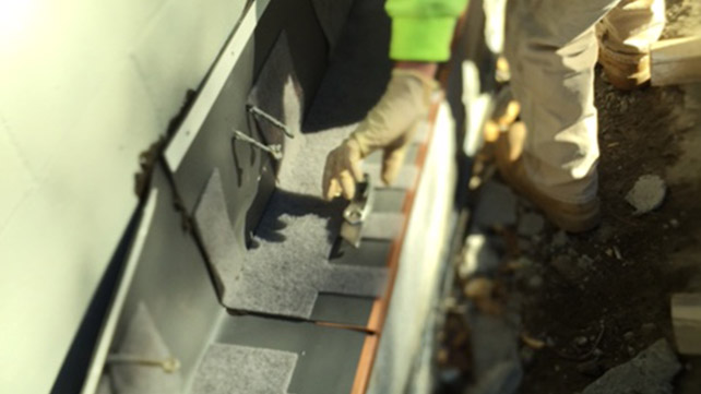 Labor saving TotalFlash through wall flashing and water management system being installed. (Note: When unavoidable penetrations occur, such as in the flashing membrane, CavityComplete Wall Systems provide MPE-1, a sealant that is fully tested for adhesion and compatibility to solve unusual job site sealing conditions that arise.)