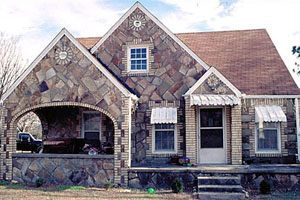 The mixed masonry method was comprised of using cream brick trim with cut sandstone and cut limestone.