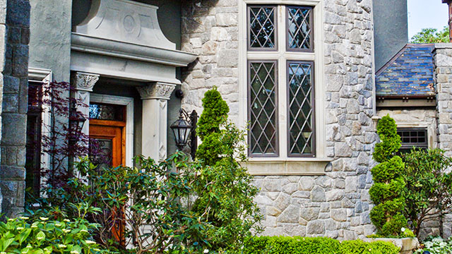 The house features hand-crafted natural stone for the window trims, entranceway, and moldings.