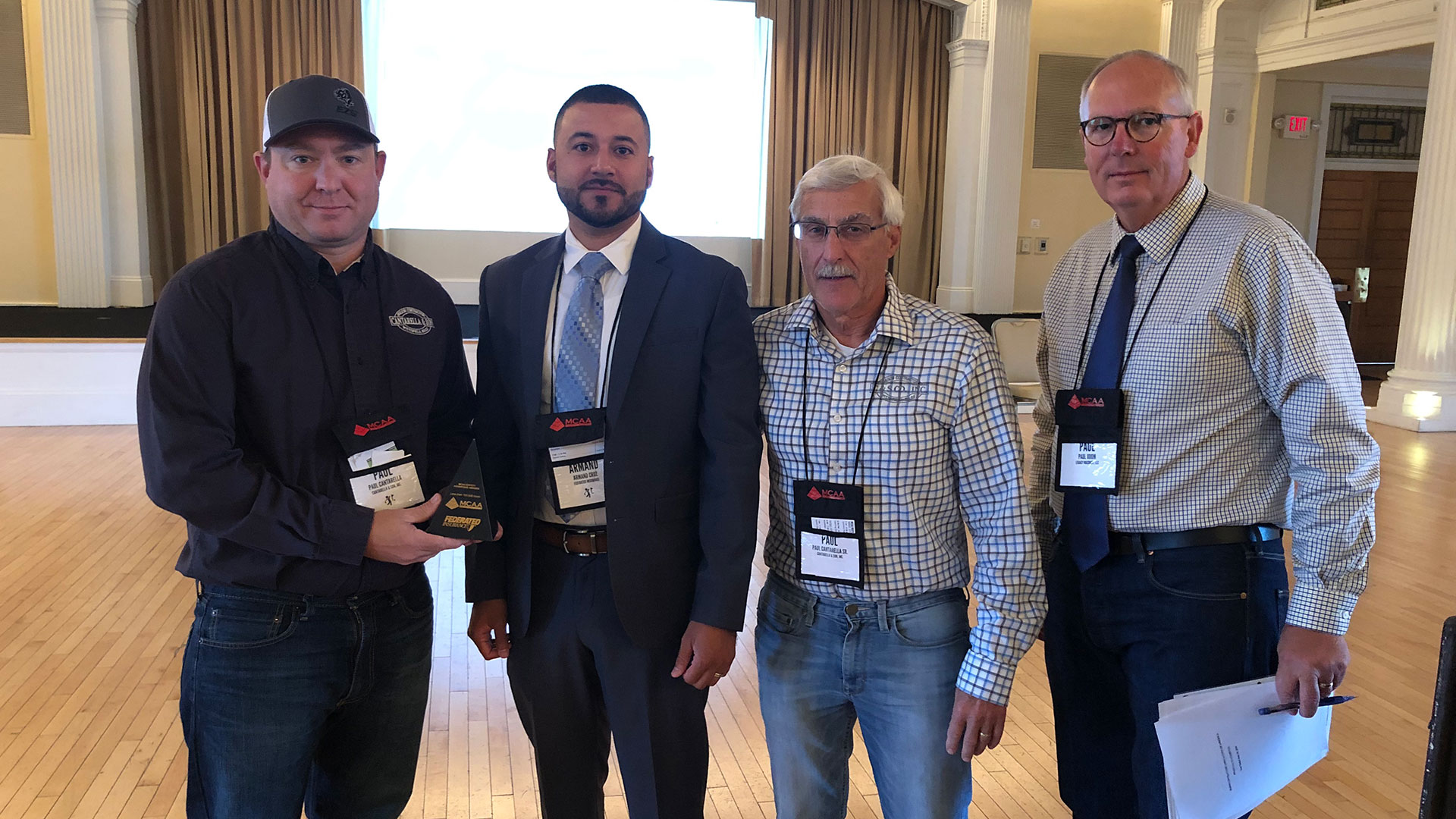 Paul Cantarella Jr. (left) and Paul Cantarella Sr. (center, right) are presented the MCAA Safety Advantage Award by Armand Cruz of Federated Insurance (center, left) and Paul Odom (right).