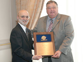 MCAA's Jerry Painter, F.ASTM, receives the ASTM Award of Merit from ASTM Chairman of the Board, Anthony Fiorato.