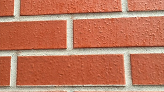 Here's a paint-like product applied less than two years earlier. Note the blisters formed in the coating, and the single-tone color. Even the mortar has a paint-like product on it. These are not proven masonry stains.