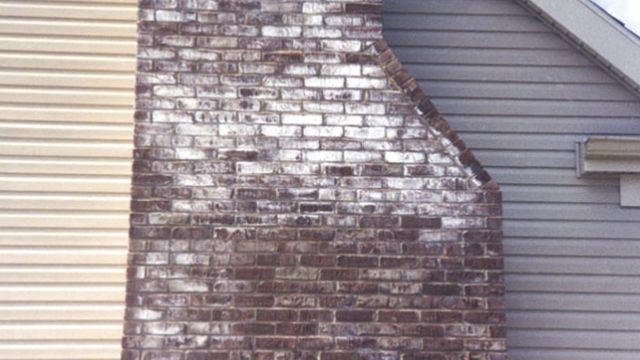 Efflorescence is shown on a masonry chimney