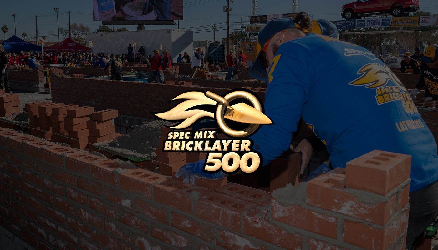 A mason and tender working a wall in the SPEC MIX BRICKLAYER 500